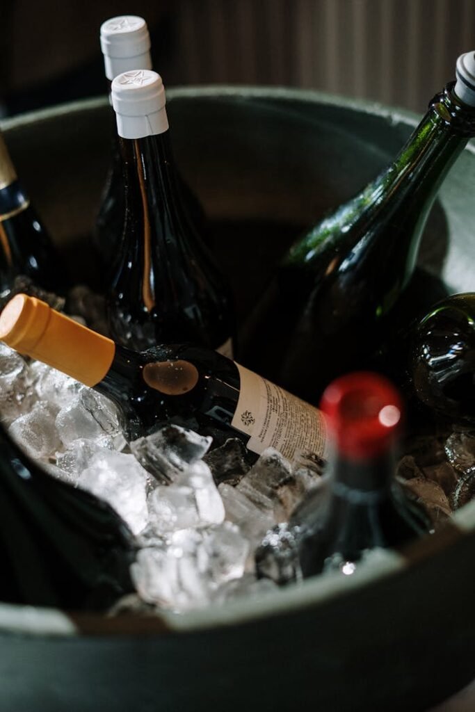 The Art of Drawing Readers In: Your attractive post title goes here A close-up view of wine bottles chilled on ice, perfect for festive occasions.