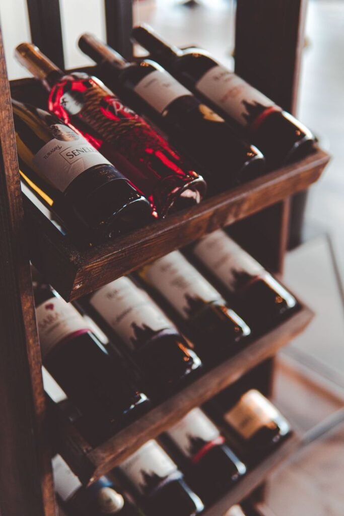 Crafting Captivating Headlines: Your awesome post title goes here Elegant wooden wine rack filled with assorted red and white wine bottles on display indoors.